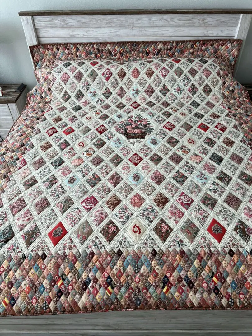 A bed with a quilt on it and pillows