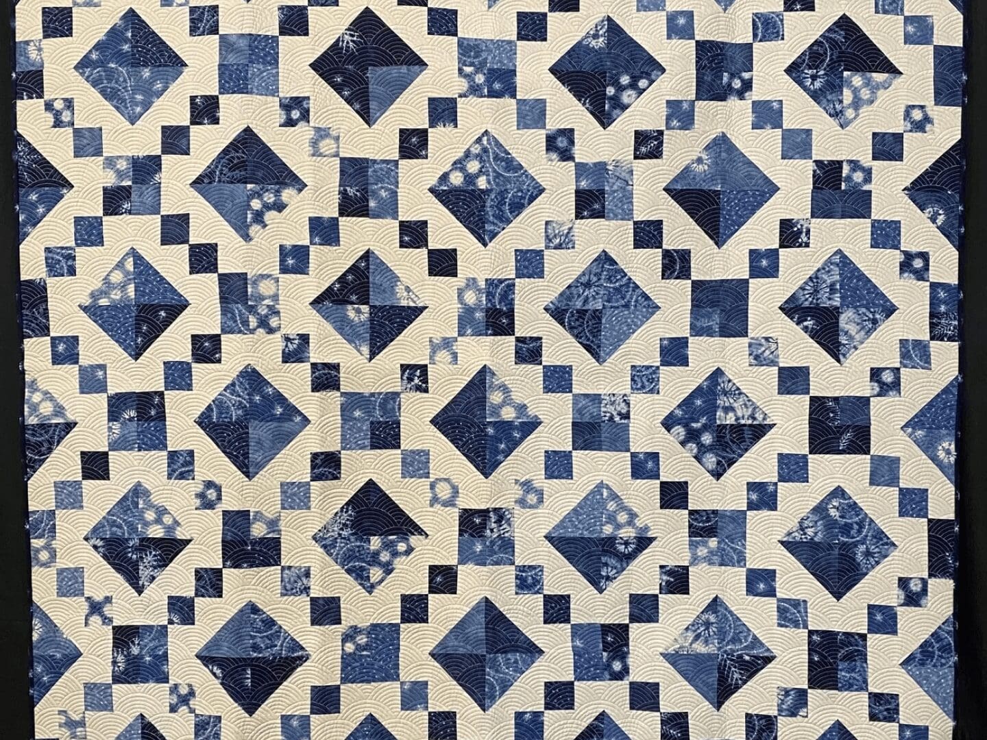 A blue and white quilt with squares on it